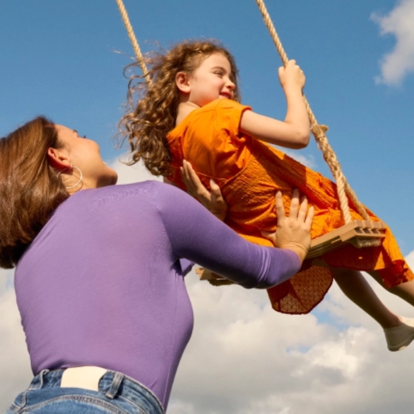 A young man peacefully laying outside on a mat in the daytime.